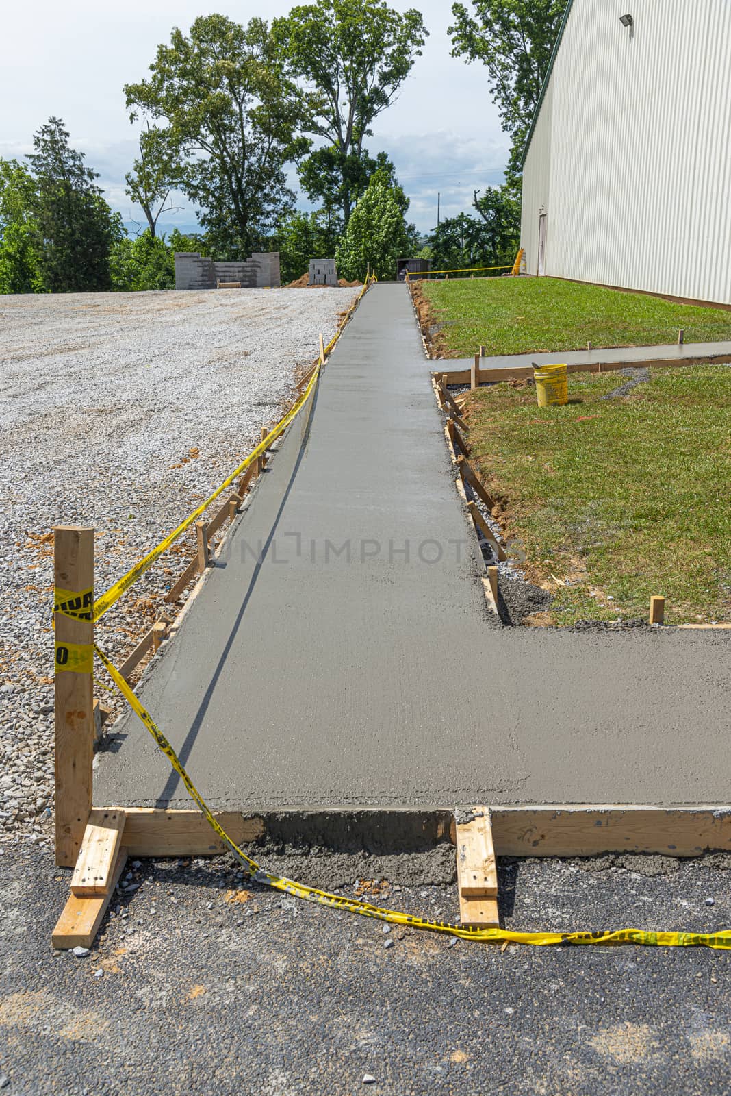 Freshly Poured Concrete Sidewalk at Construction Site by stockbuster1