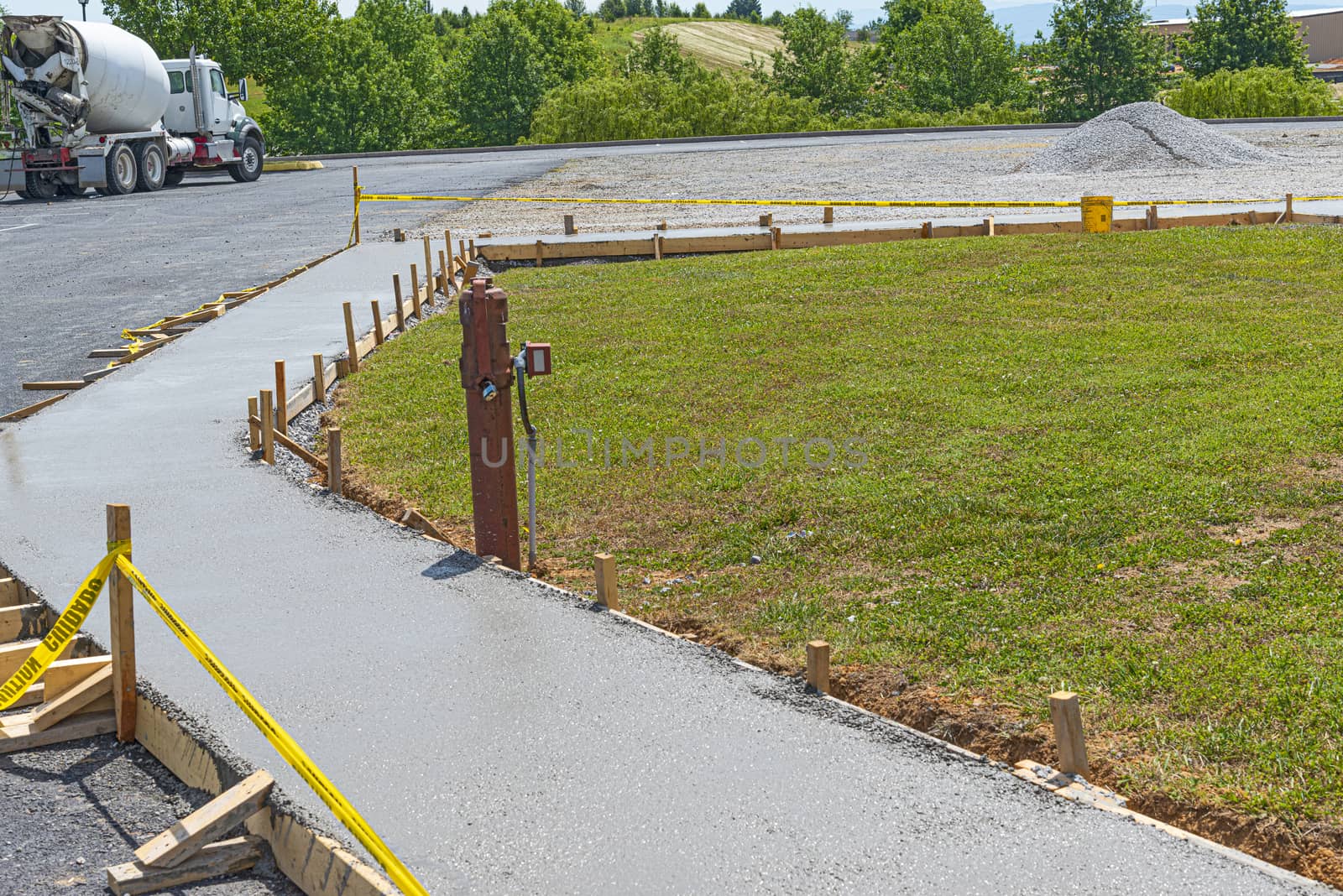 Horizontal shot of a new concrete sidewalk that has just been poured.