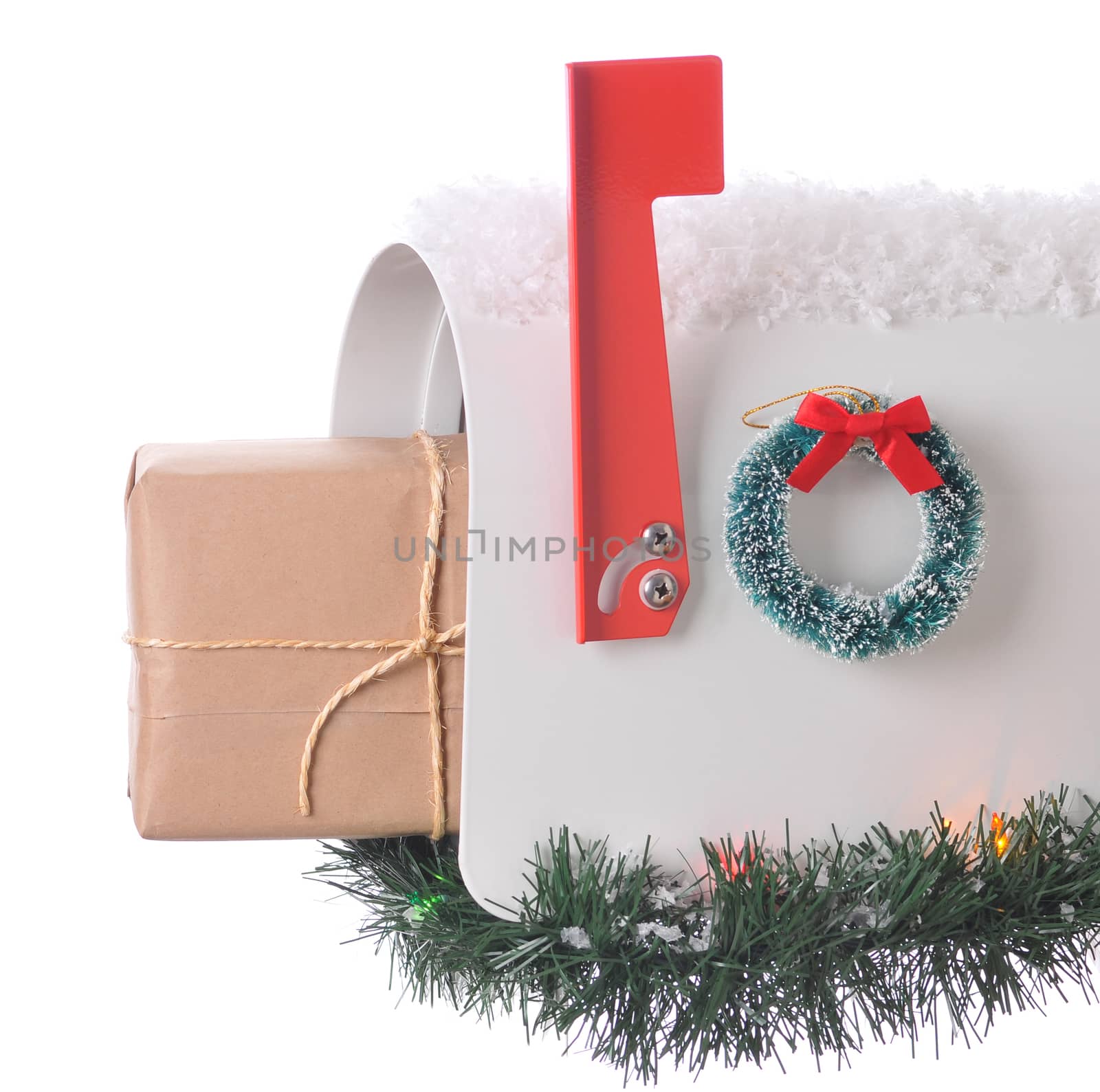Package sticking out of and open mailbox decorated for christmas isolated on white. Square Composition