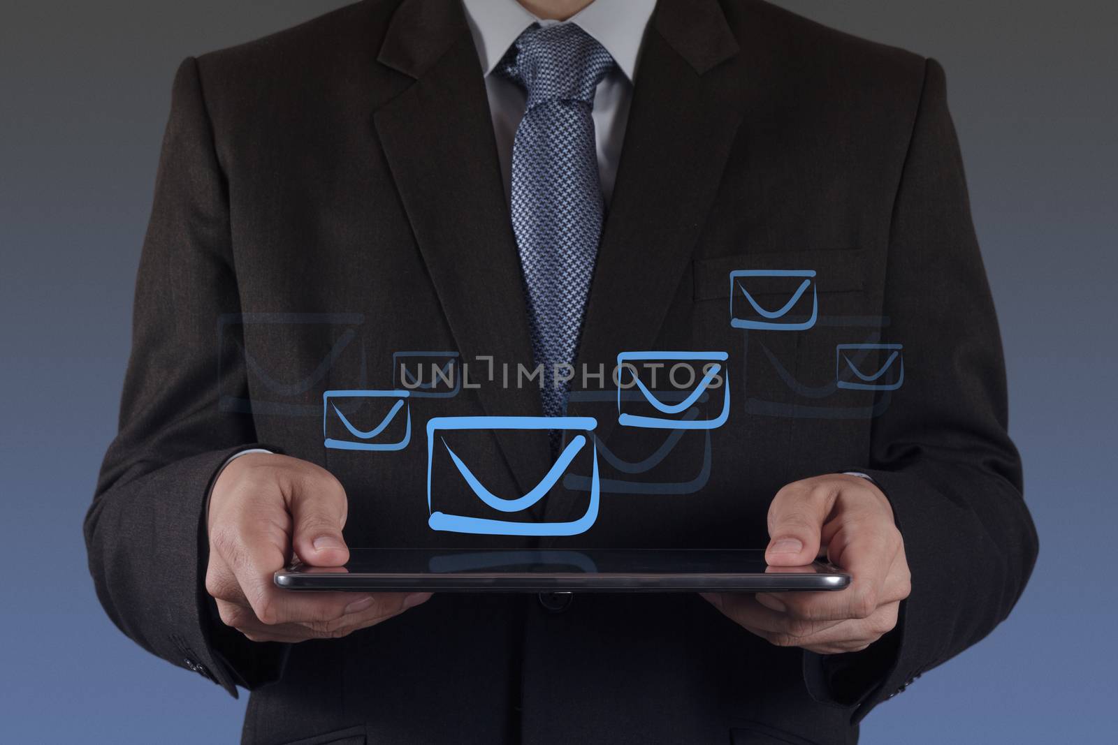 businessman hand use tablet computer with email icon