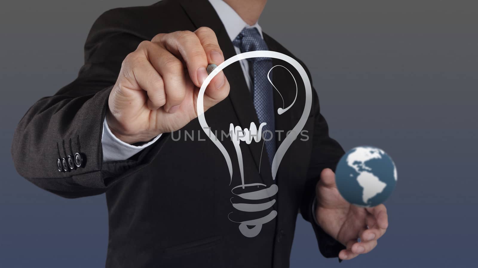businessman hand with a pen drawing light bulb