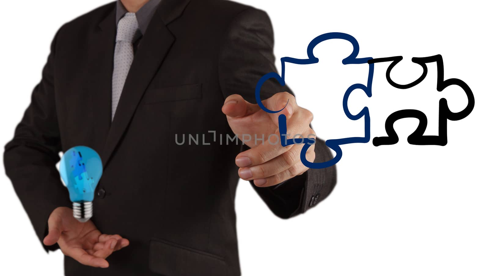 businessman hand shows light and puzzle partnership
