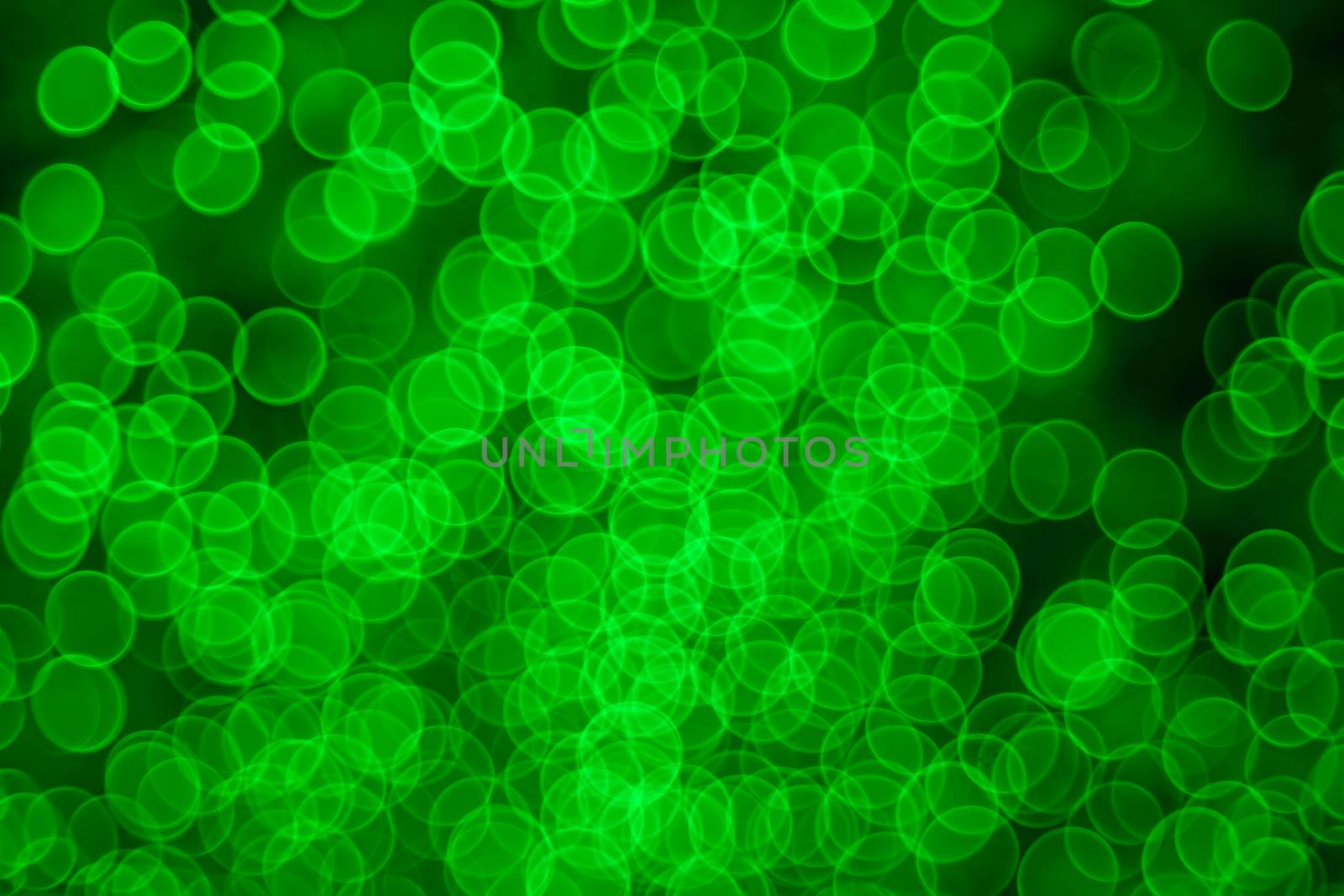 Classic bokeh “soap bubbles” light green. Festive Christmas elegant abstract background with booble bokeh lights. Background with defocused lights. Copy space.