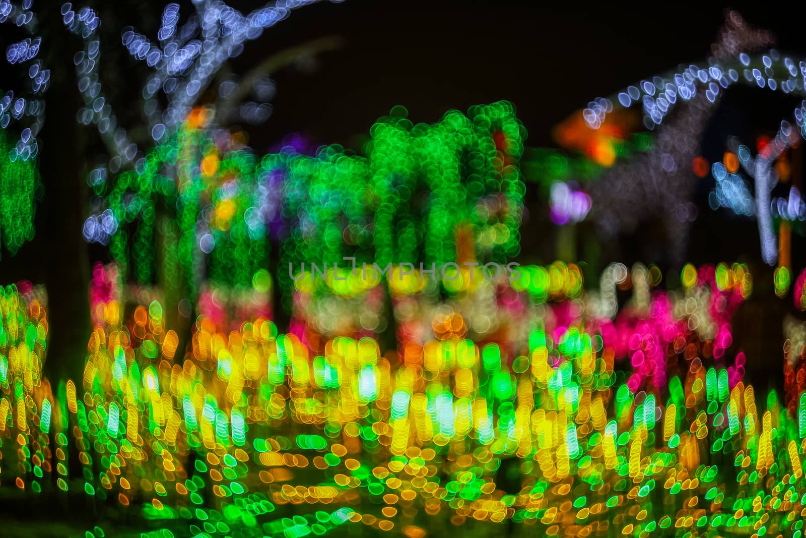 Festive abstract background with bubble bokeh defocused lights. Majestic tree of lights. Fantastic forest. Copy space.