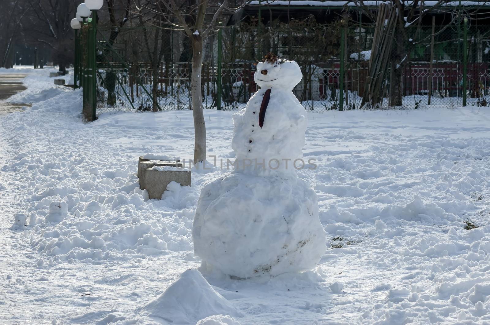 Winter scene with a snowman made with handy materials in the park, Sofia, Bulgaria