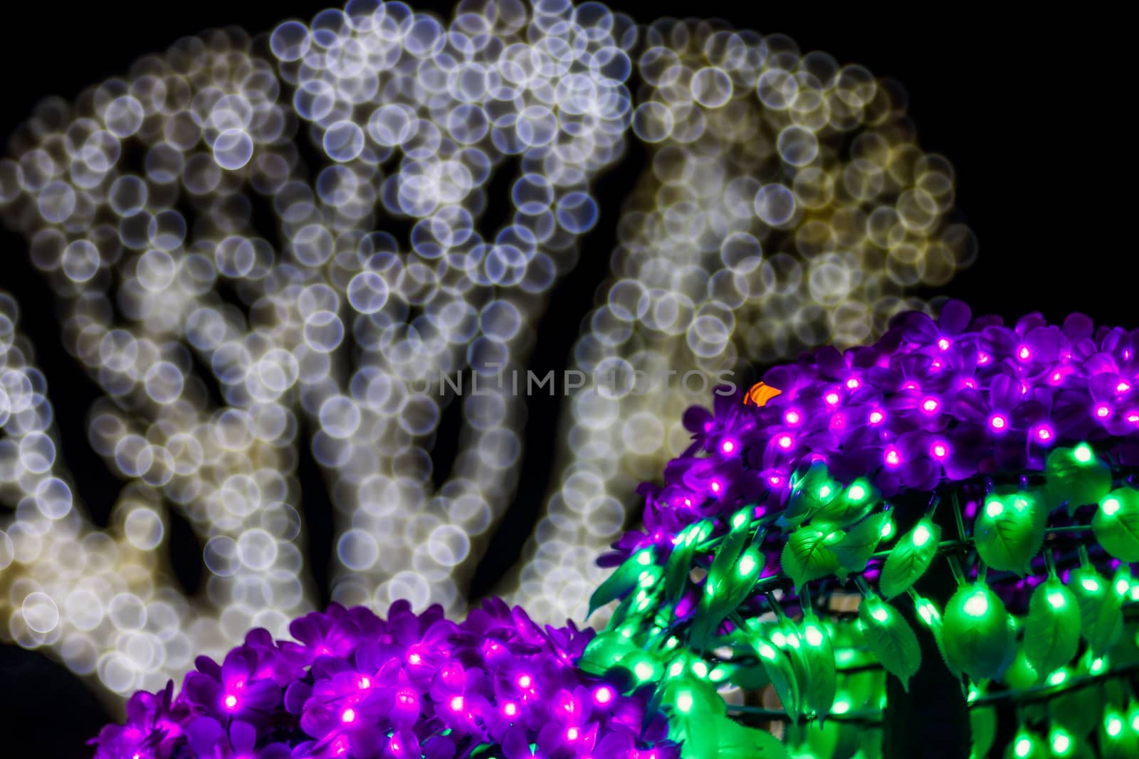 Abstract twinkled bright background with defocused lights. Majestic tree of lights. Fantastic forest. Unique bokeh effect.