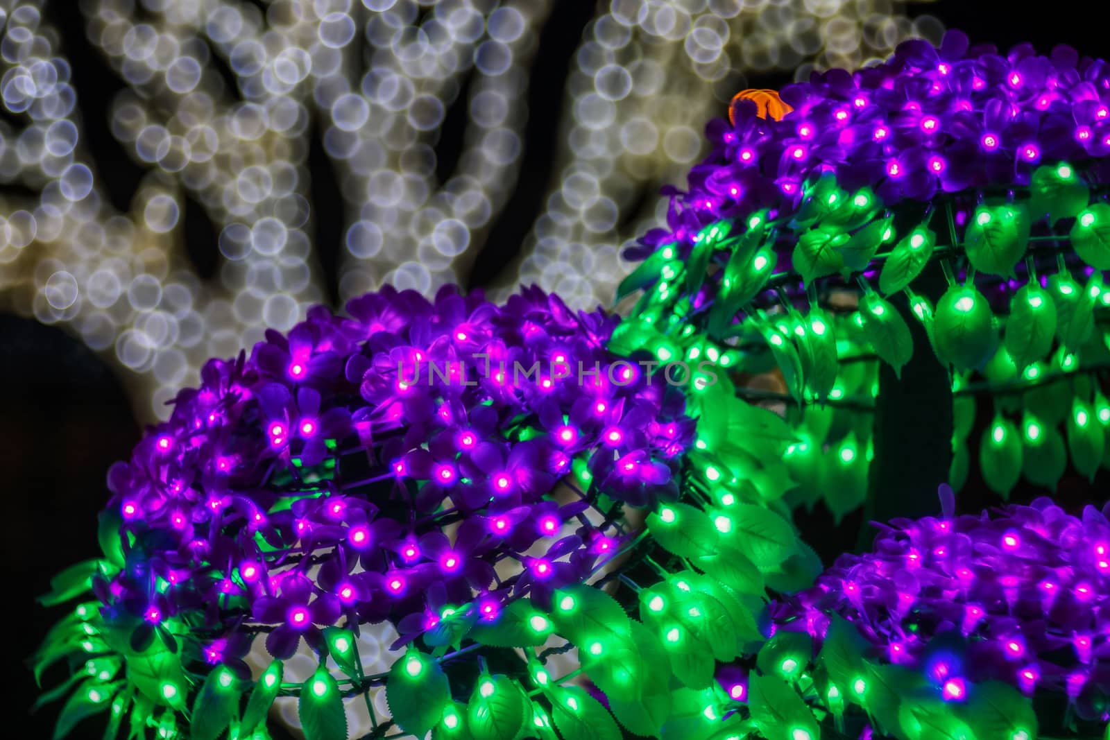 Festive abstract background with bubble bokeh defocused lights. Majestic tree of lights. Fantastic forest. Copy space.