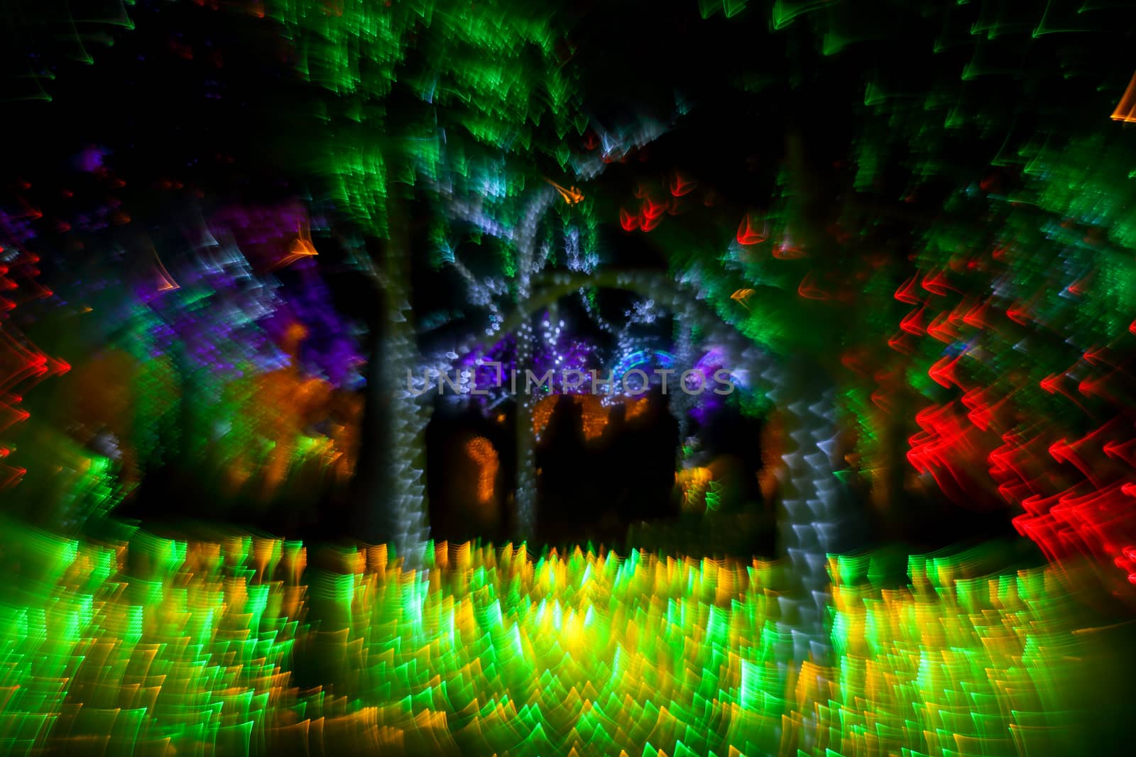 Abstract twinkled bright background with defocused lights. Majestic tree of lights. Fantastic forest. Unique bokeh effect.