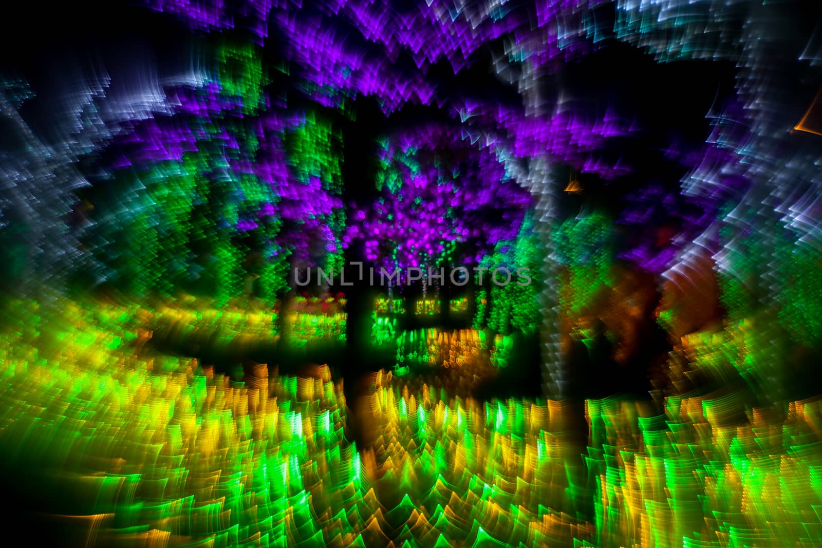 Abstract twinkled bright background with defocused lights. Majestic tree of lights. Fantastic forest. Unique bokeh effect.