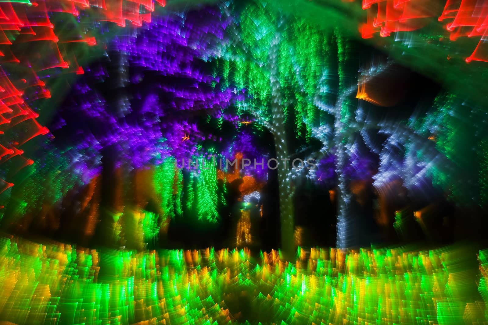 Abstract twinkled bright background with defocused lights. Majestic tree of lights. Fantastic forest. Unique bokeh effect.

