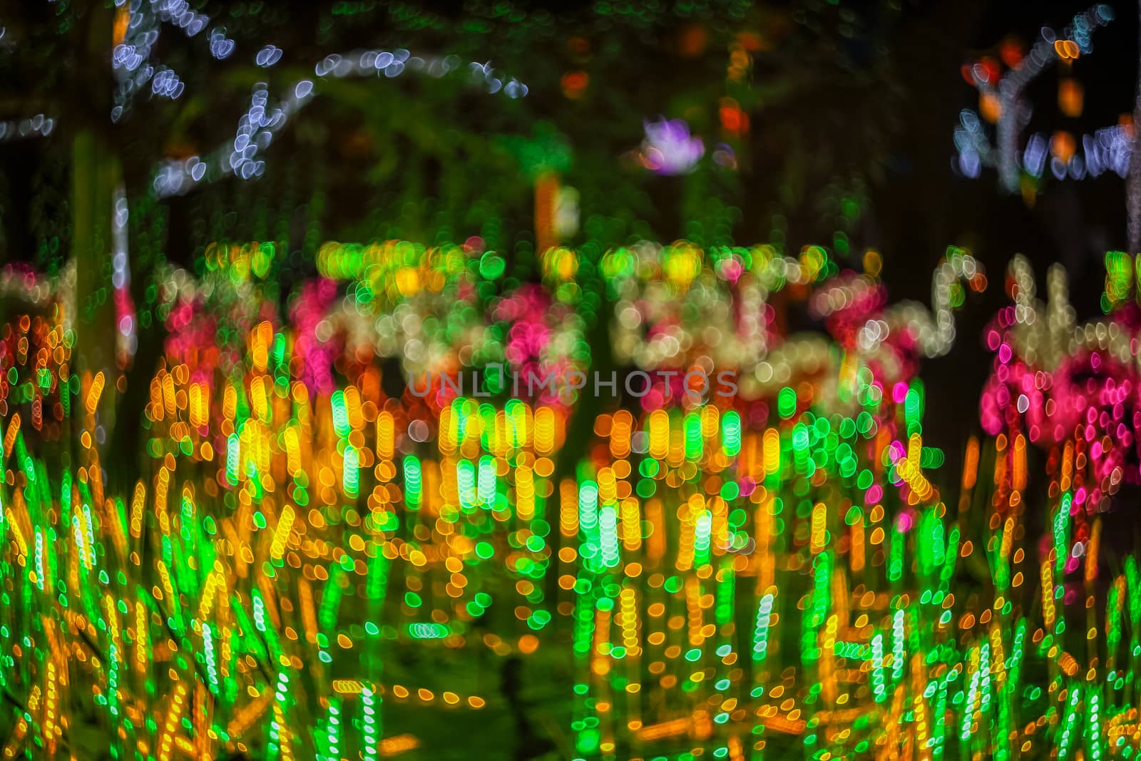 Festive abstract background with bokeh defocused lights. Majestic tree of lights. Fantastic forest. Copy space.