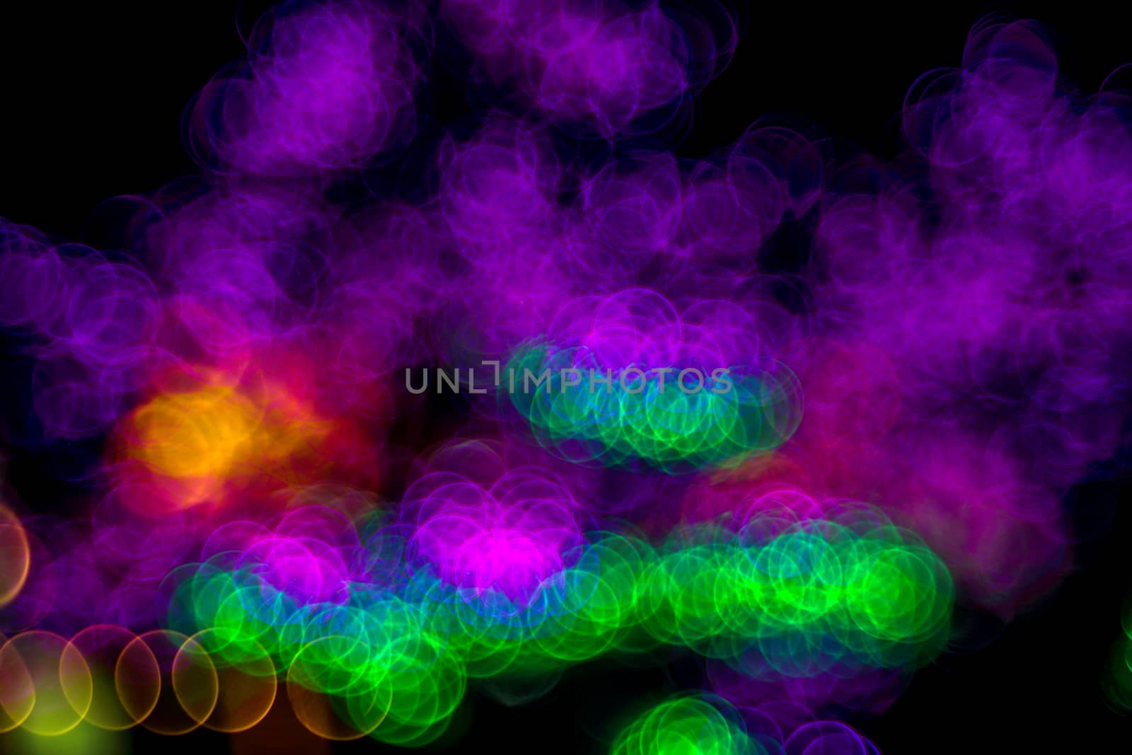Festive Christmas elegant abstract background with bubble bokeh multicolored lights. Background with defocused lights. Neon color. Copy space.
