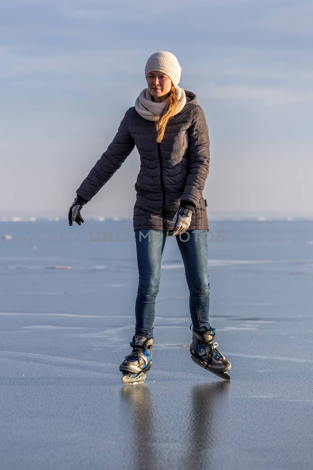 Young girl skating on Lake Balaton in Hungary by Digoarpi