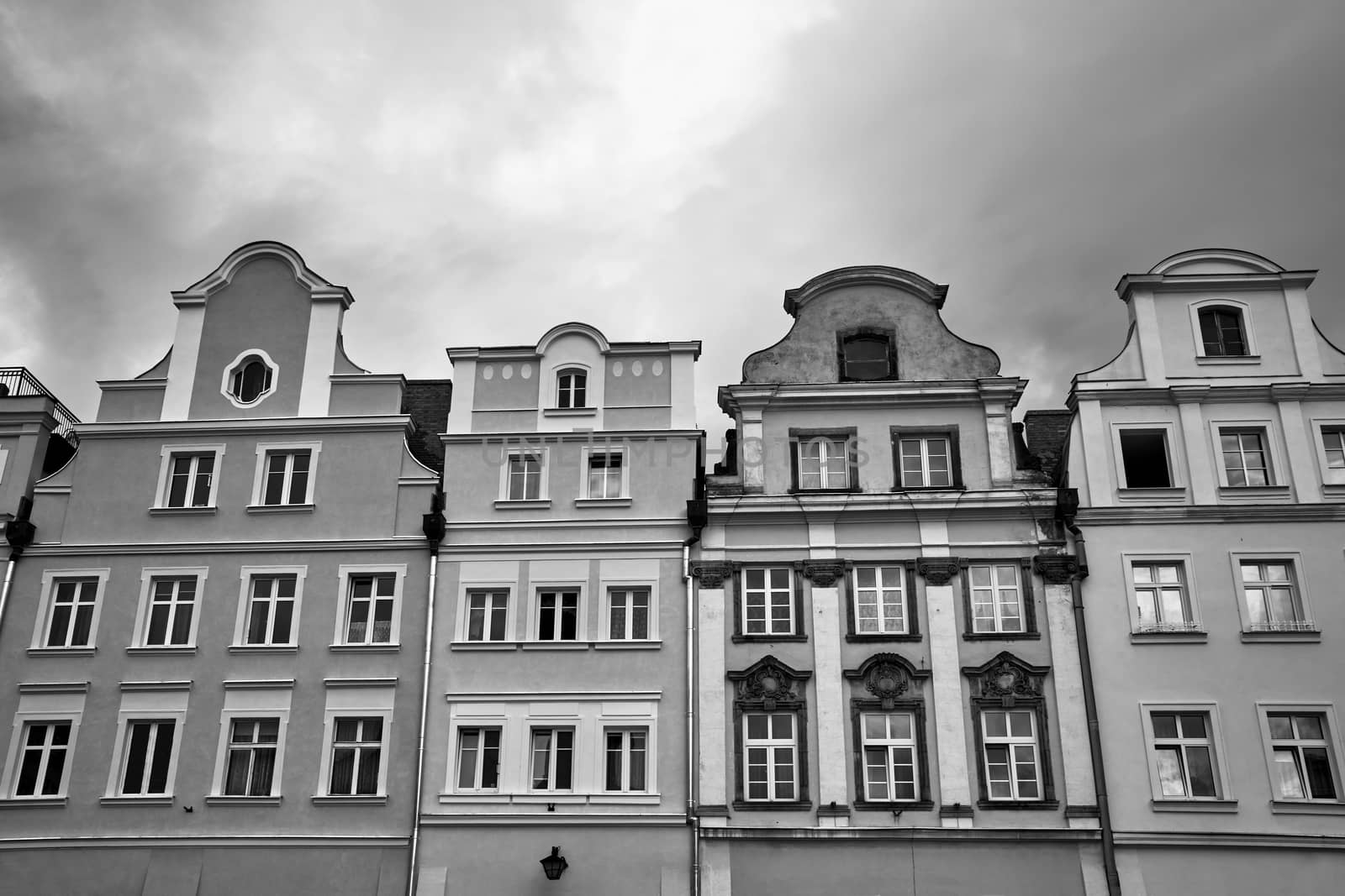 Facades of historic tenement houses on the market square in Jelenia Gora in Poland, black and white
