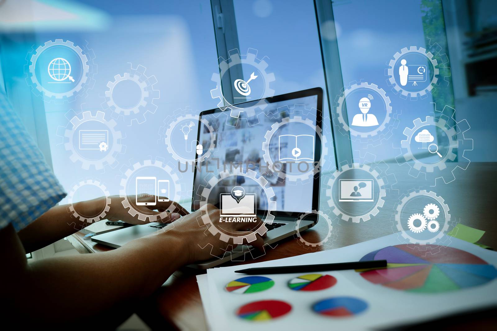  E-learning with connected gear cogs connected diagram virtual dashboard.business documents on office table with smart phone and digital tablet and graph business diagram and man working in the background                              