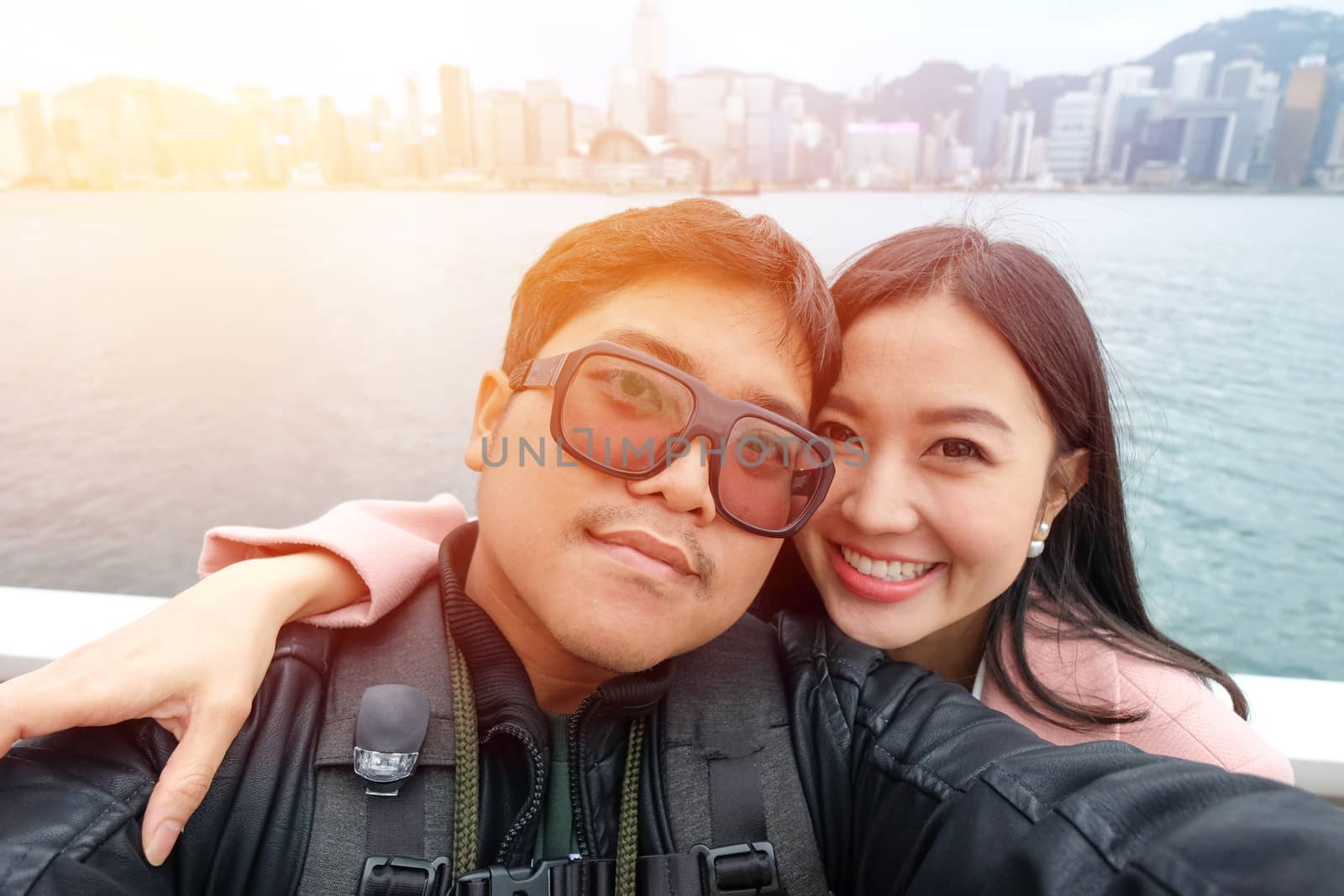 Young Couple Tourists in Victoria harbour at Hong kong city 