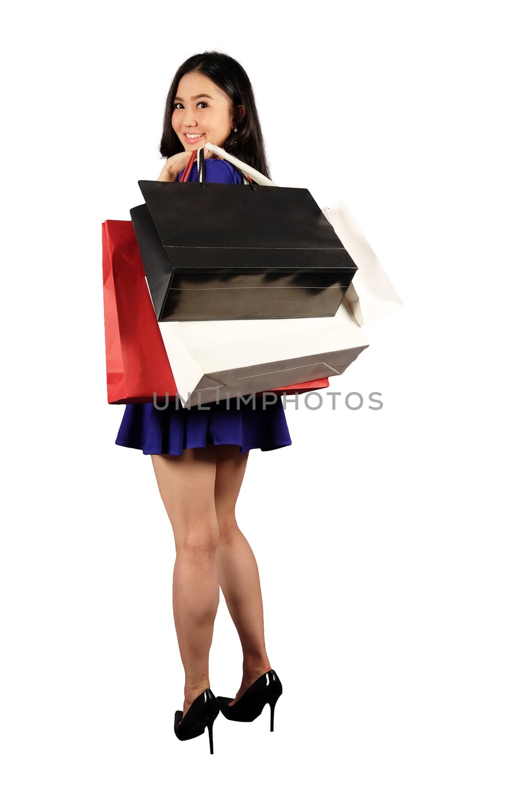 Happy women in blue dress with a shopping bag on white background and clipping path