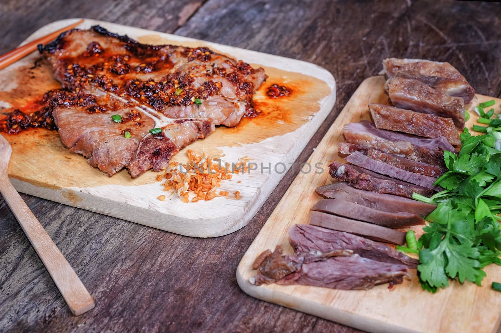 T-bone steak medium-rear steak with sliced beef on wooden backgr by Surasak