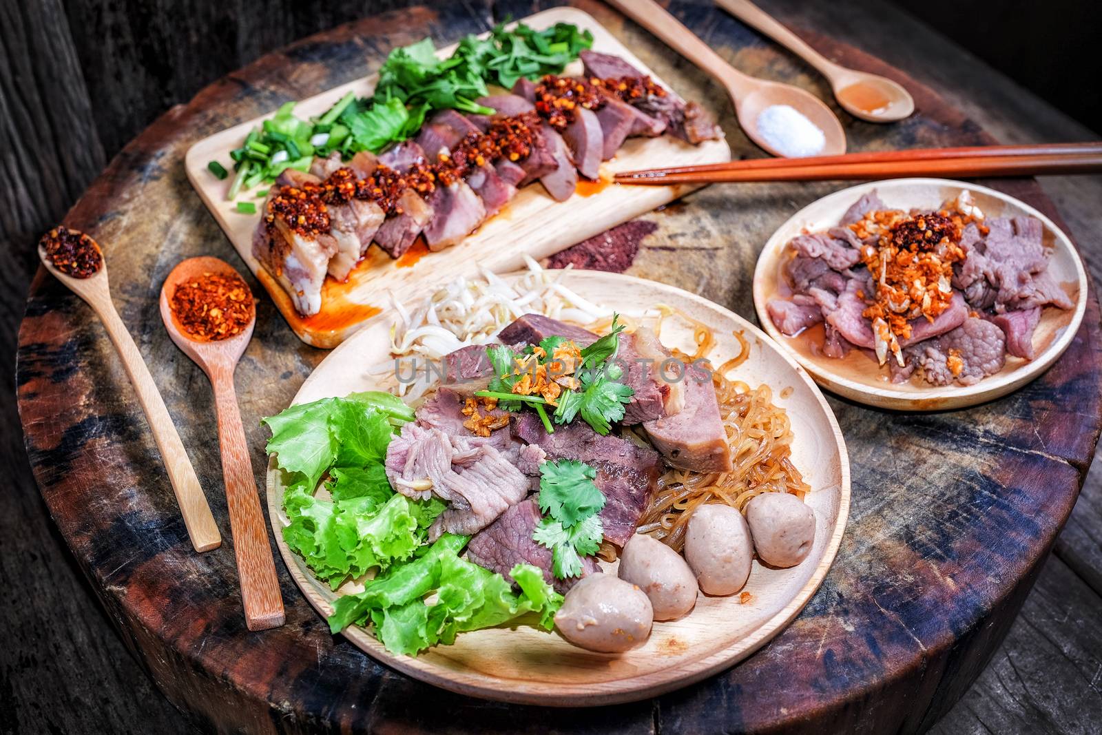 Thai food Noodle soup with beef on wood background by Surasak