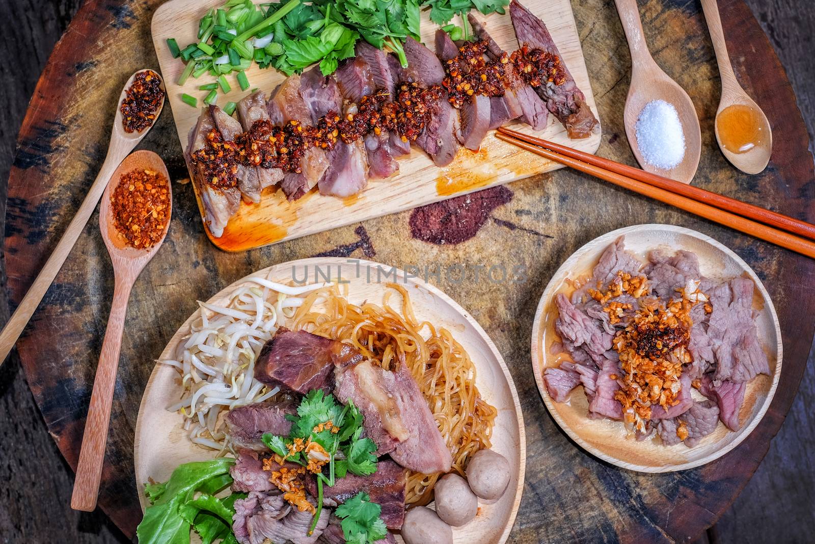 Thai food Noodle soup with beef on wood background by Surasak