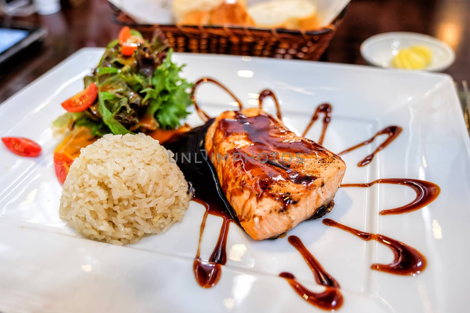 Grilled salmon and vegetables with rice in Restaurant by Surasak