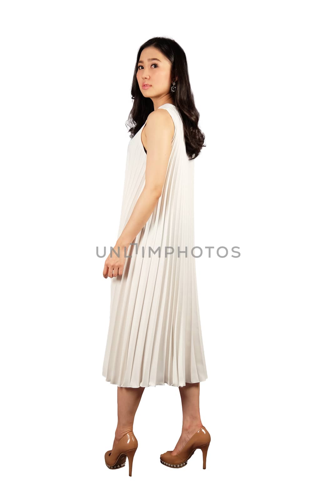 Young asian woman in white dress looking at the camera on white  by Surasak