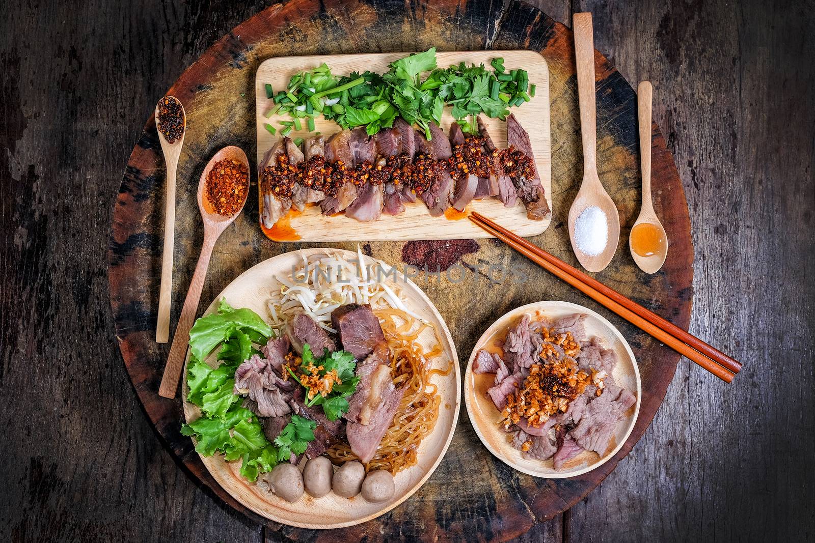 Thai food Noodle soup with beef on wood background by Surasak