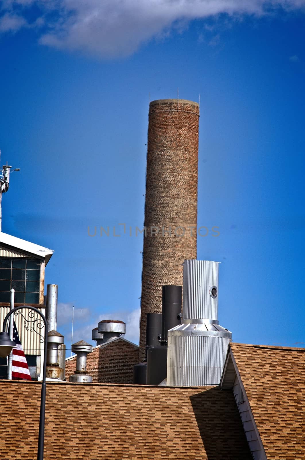 This is a unique collection of vents and smoke stacks  on a  bright day. 