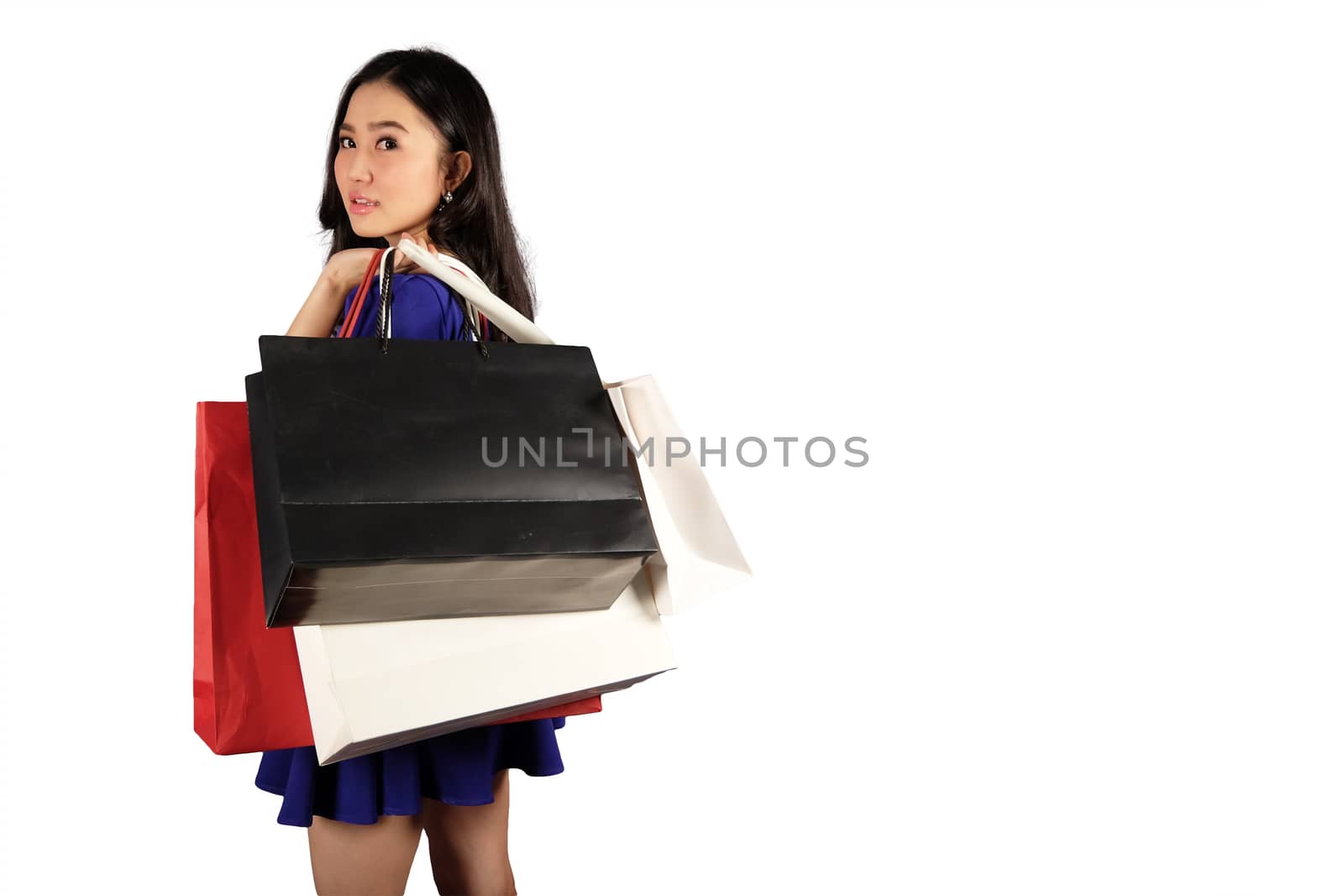 Happy women in blue dress with a shopping bag on white background and clipping path with space for text