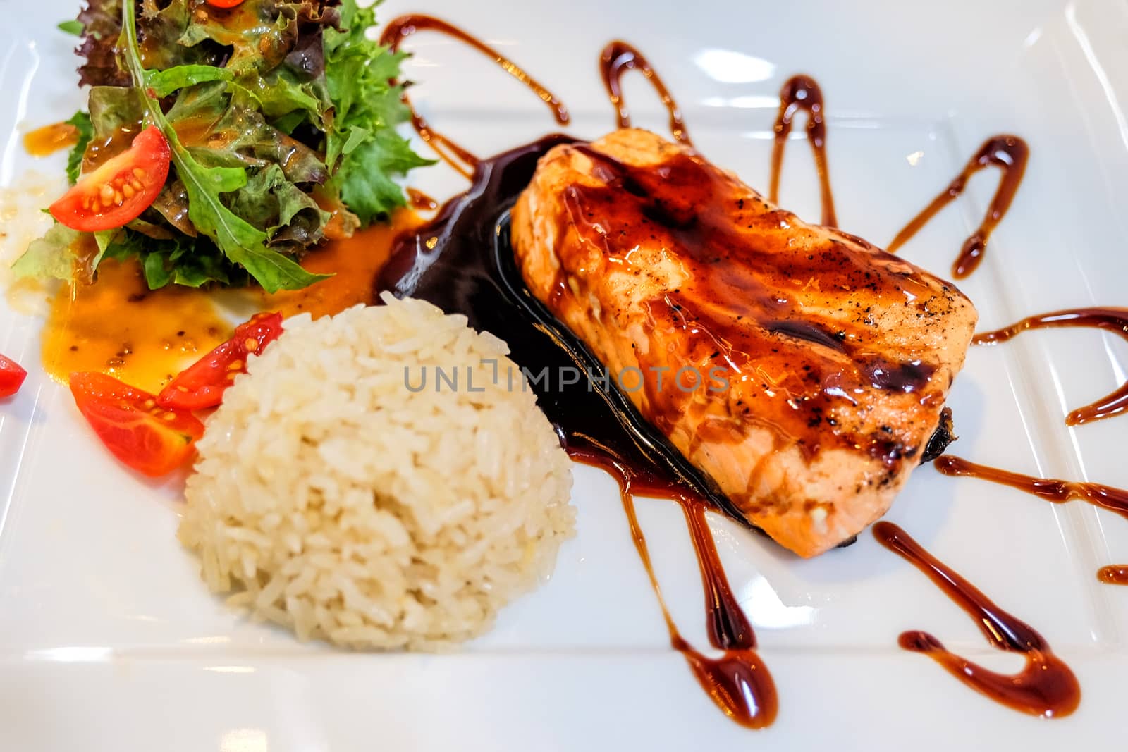 Grilled salmon and vegetables with rice in Restaurant by Surasak