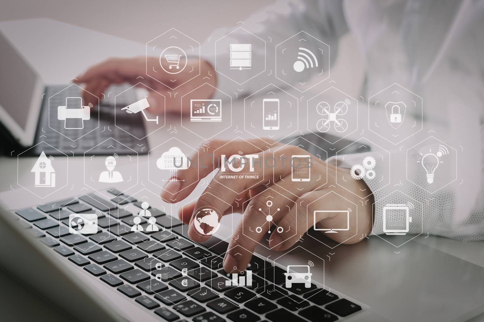 Internet of Things (IOT) technology with AR (Augmented Reality) on VR dashboard. businessman typing digital tablet with keyboard and laptop computer on white desk in modern office