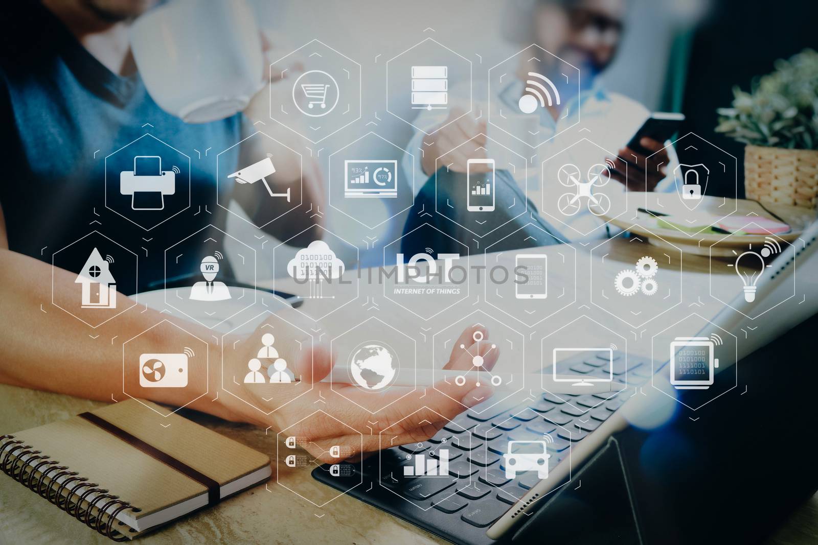 Internet of Things (IOT) technology with AR (Augmented Reality) on VR dashboard. co working website designers working at office and holding a cup of coffee,working on smart phone and digital tablet computer docking 