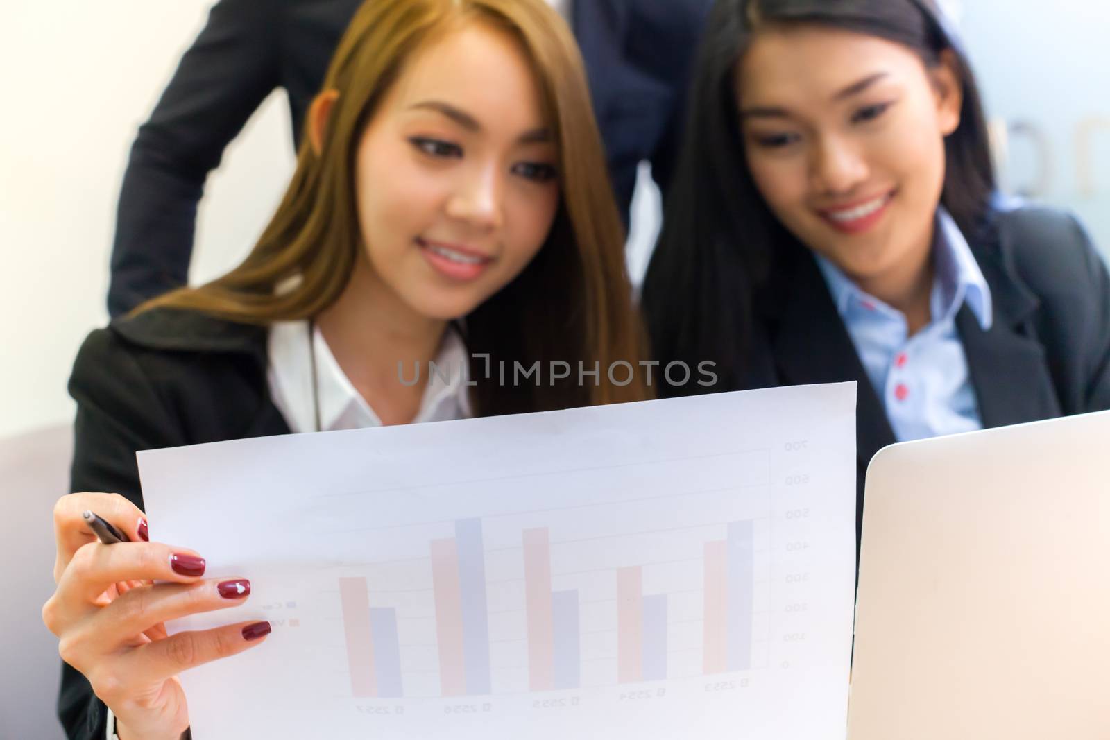 Asian business people make a group discussion in meeting room by pattierstock