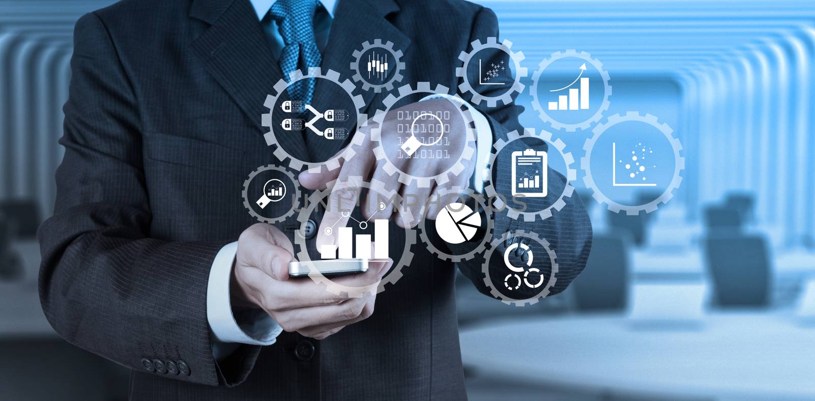 Business data analytics management with connected gear cogs with KPI financial charts and graph.businessman hand use smart phone computer with email icon as concept