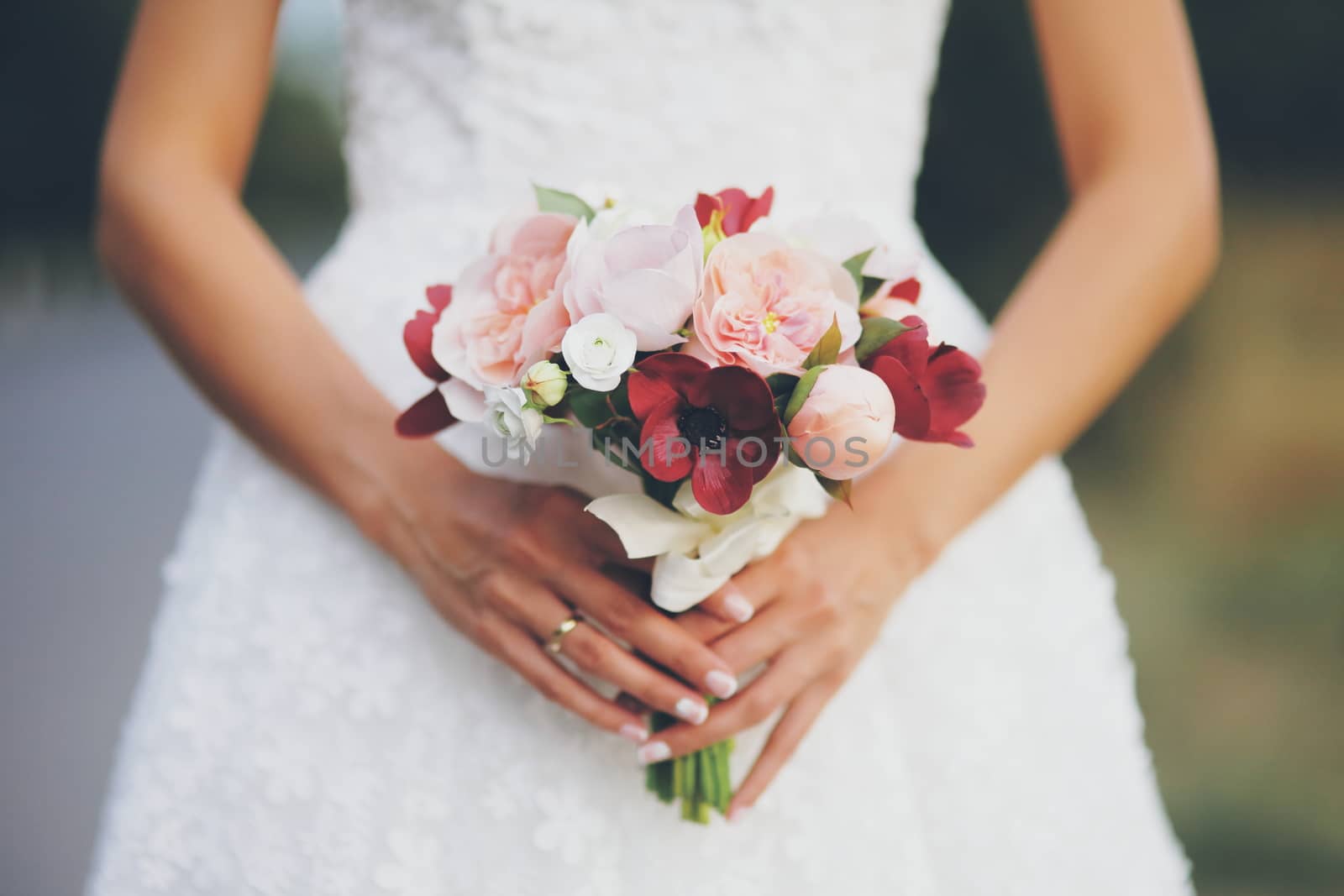 The bride holds a wedding bouquet. Women's hands with flowers. Wedding. A beautiful couple. High quality photo