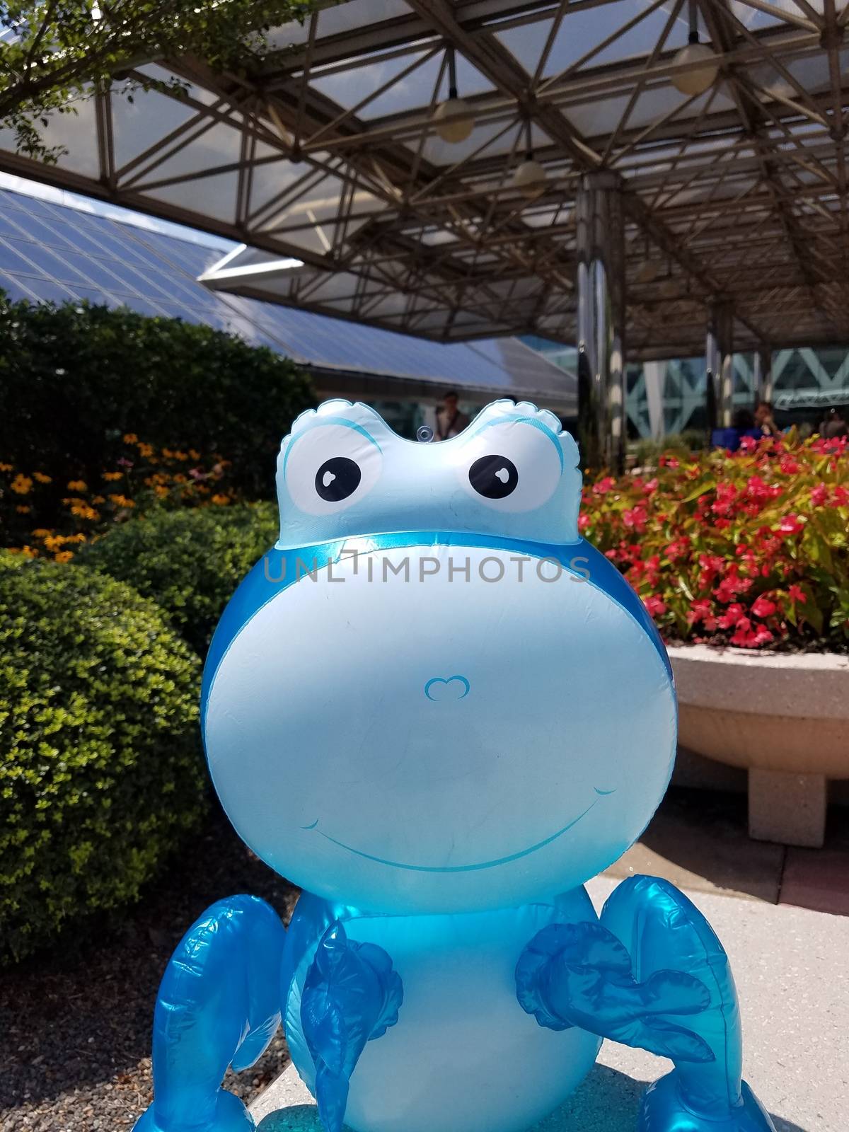 a large blue balloon animal with flowers in the background