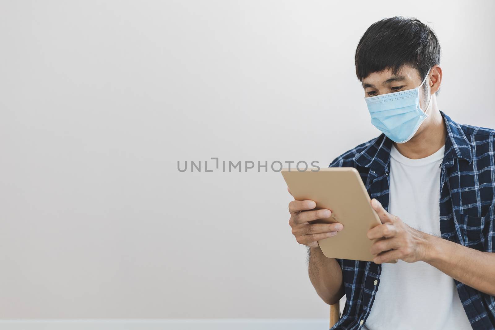 Asian man business wear surgical mask creative working online work from home and  shopping online payment price e-commerce shopping online in home lifestyle to new normol