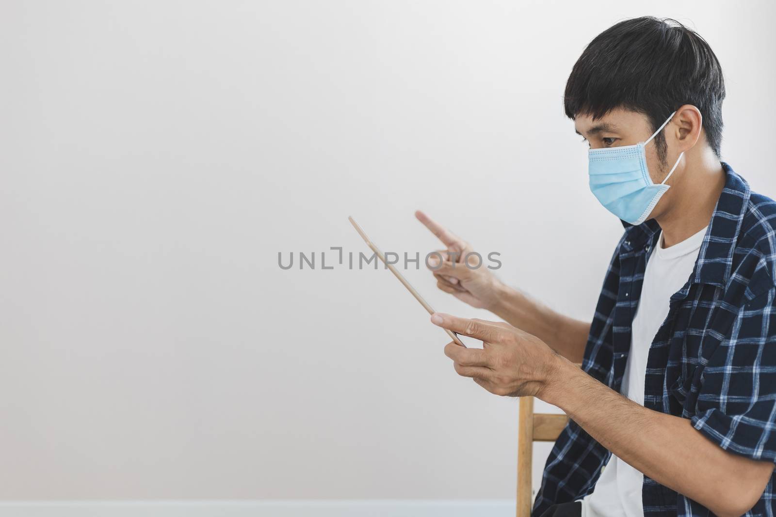 Asian man business wear surgical mask creative working online work from home and  shopping online payment price e-commerce shopping online in home lifestyle to new normol