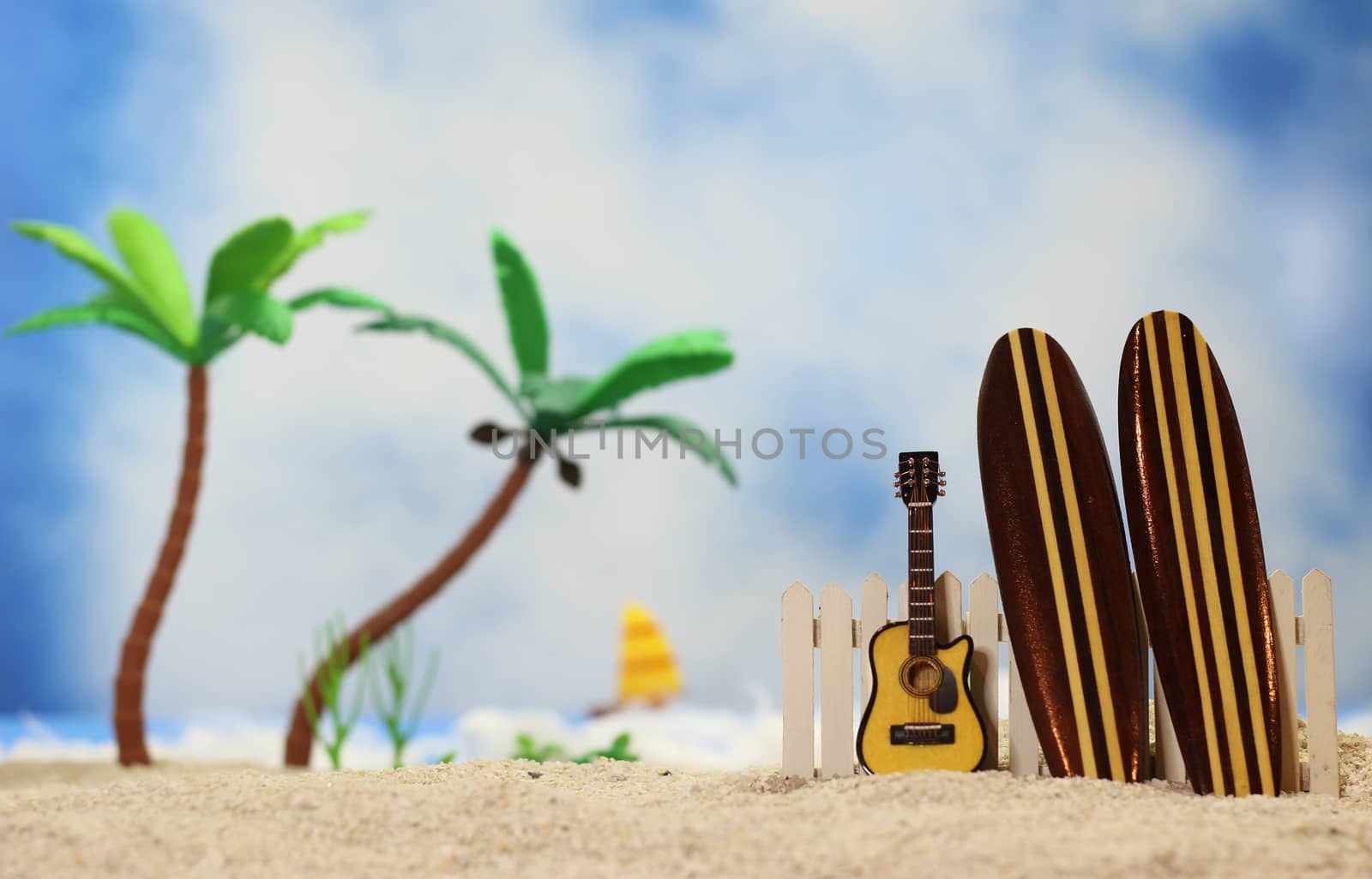 Surfboards on Tropical Beach - Shallow DOF, focus on top of guitar and fence