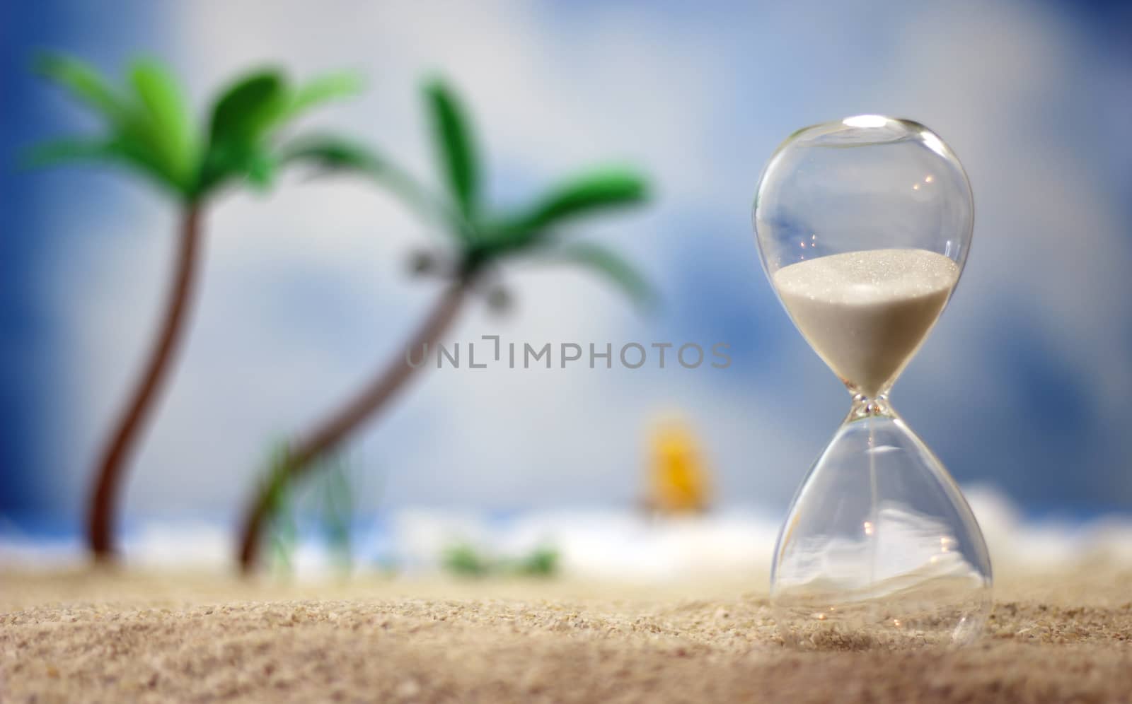 Hourglass on Tropical Beach With Palm Trees