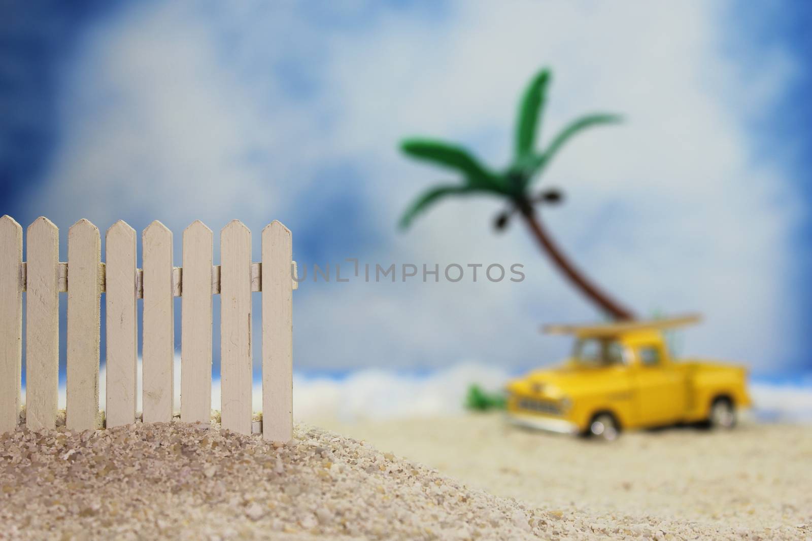 Fence on Tropical Beach With Vintage Hot Rod in Background