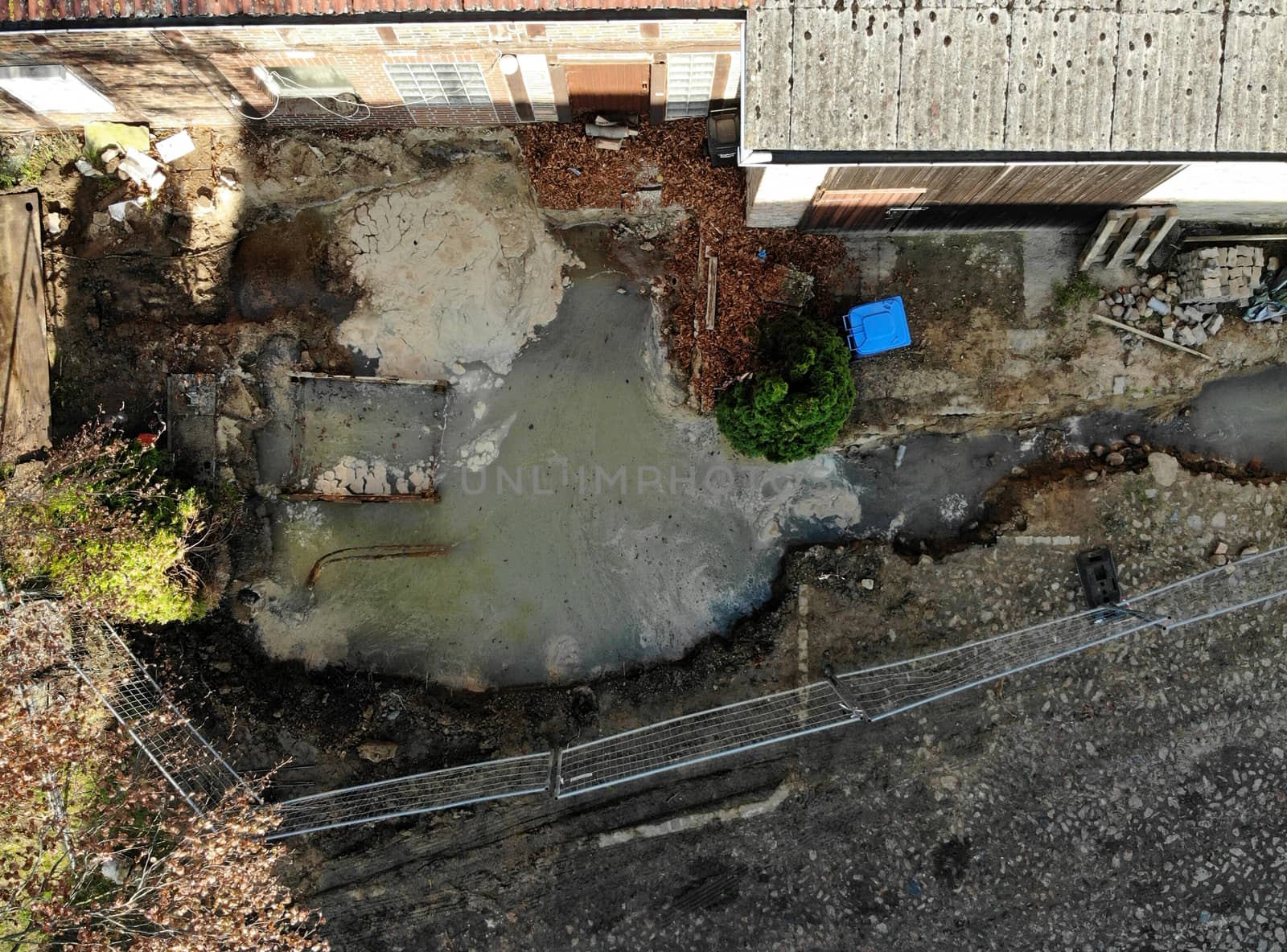 Aerial view with vertical angle of view of an excavation pit filled with liquid soil by geogif
