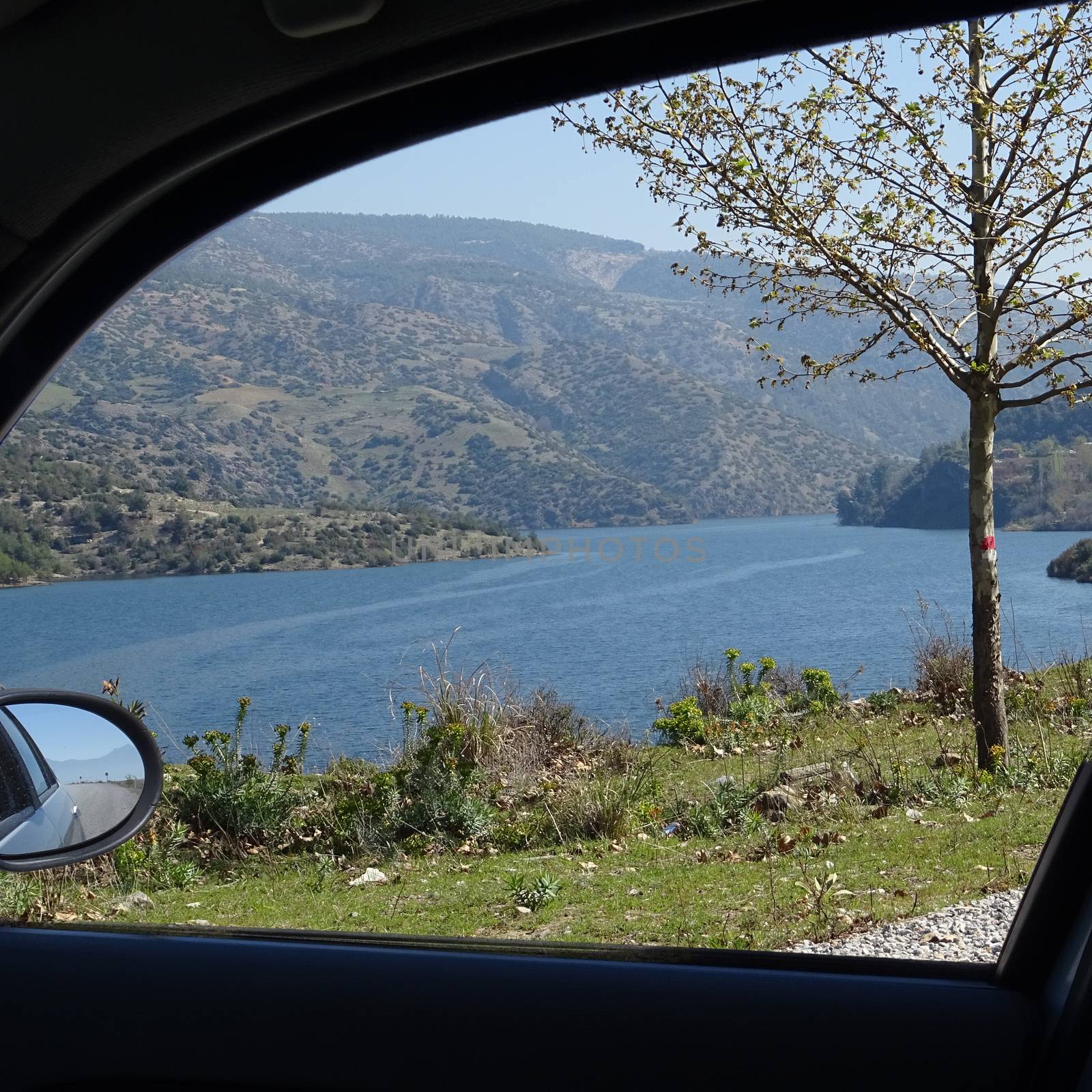 View through the side window of a rental car to a reservoir in the heart of Anatolia, Turkey