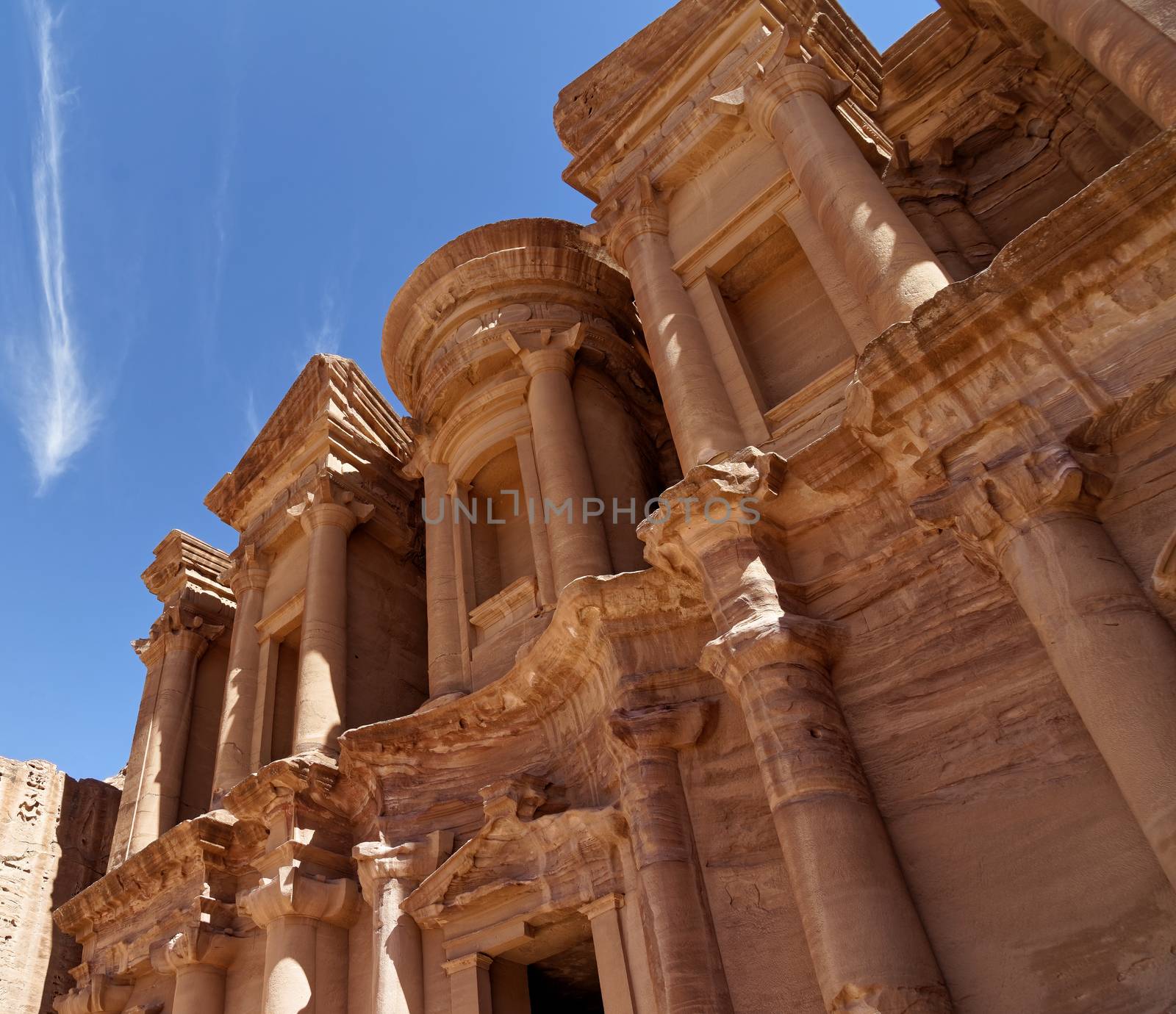 Photo taken at an oblique angle of a section of Al-Deir, the so-called monastery, in the necropolis of Petra, Jordan