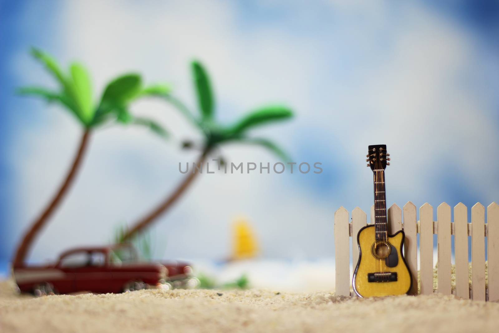 Acoustic Guitar on Tropical Beach With Palm Trees