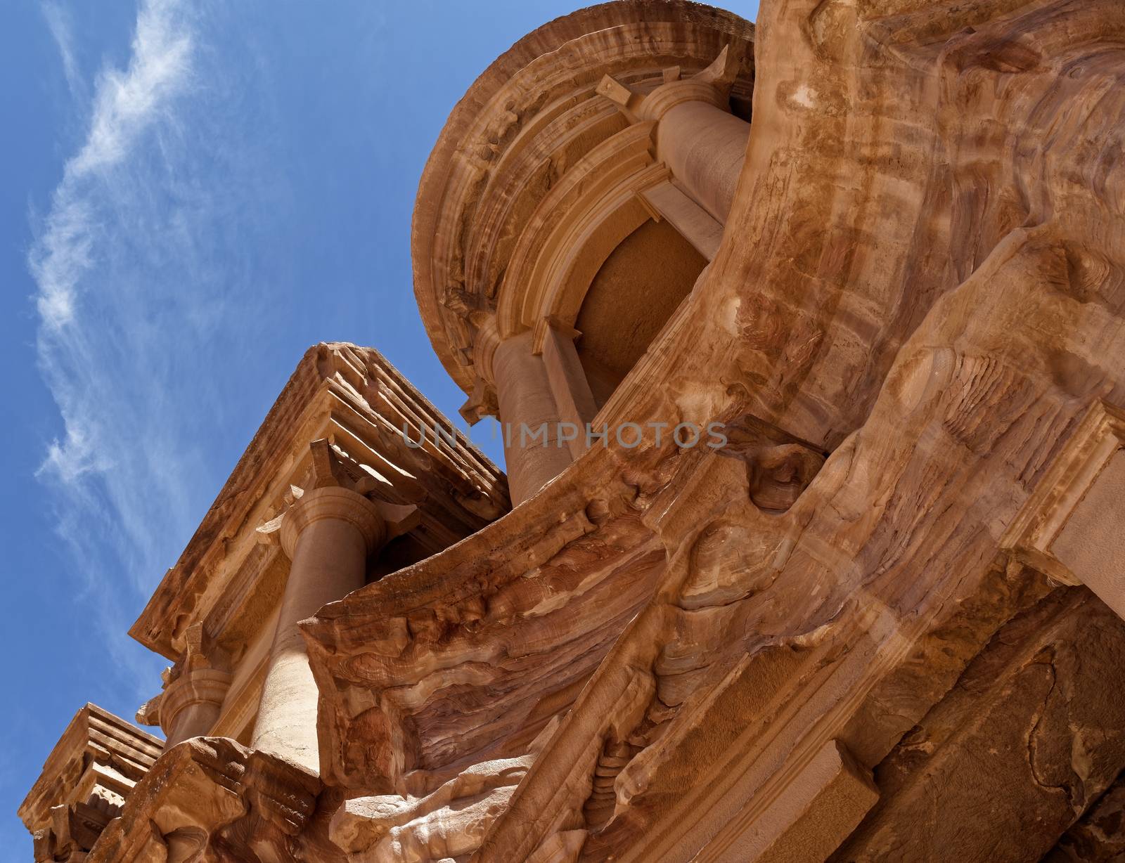Photo taken at an oblique angle of a section of Al-Deir, the so-called monastery, in the necropolis of Petra, Jordan