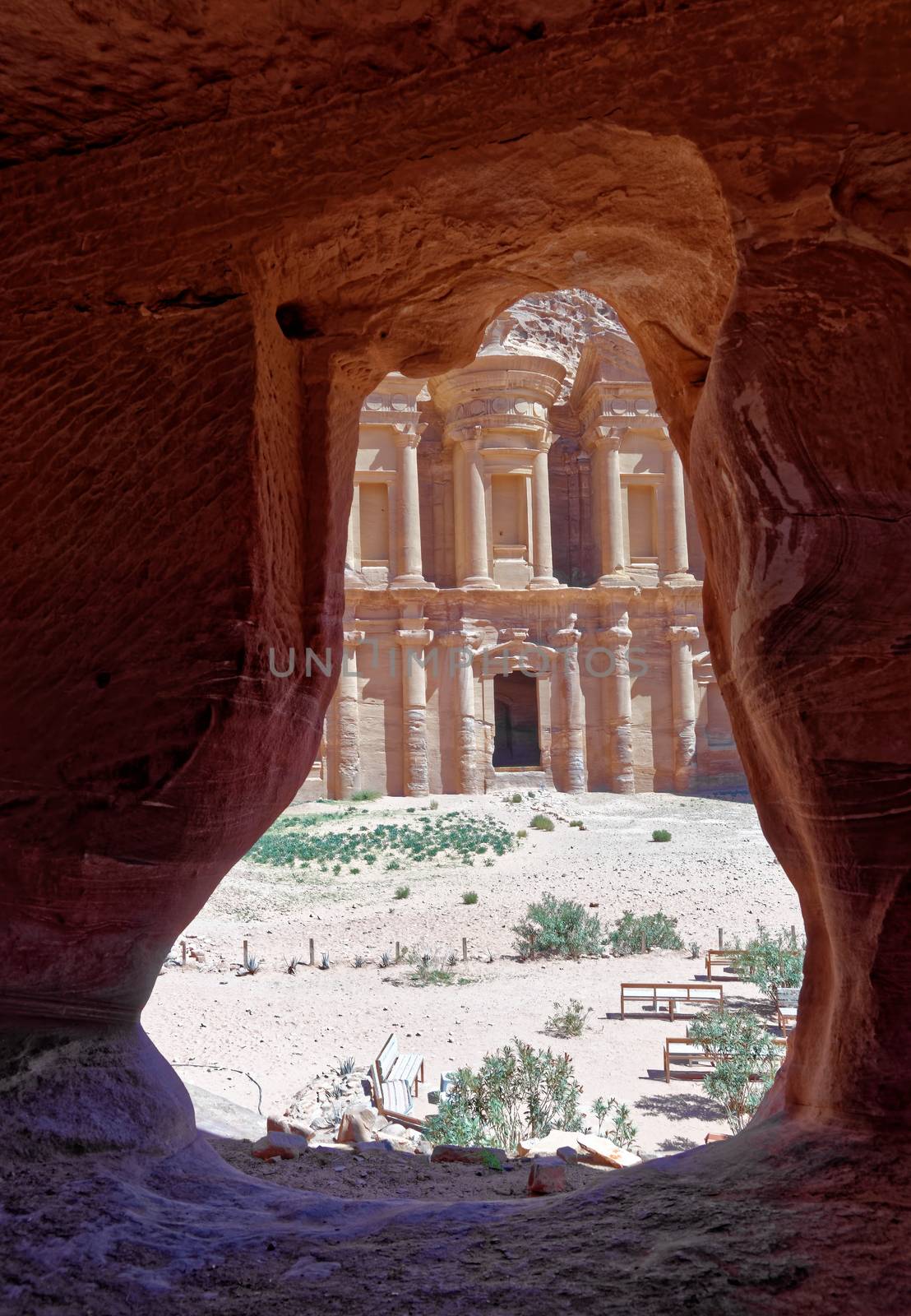 View through the rock window of a storage room in Petra to the monastery Al-deir, Jordan