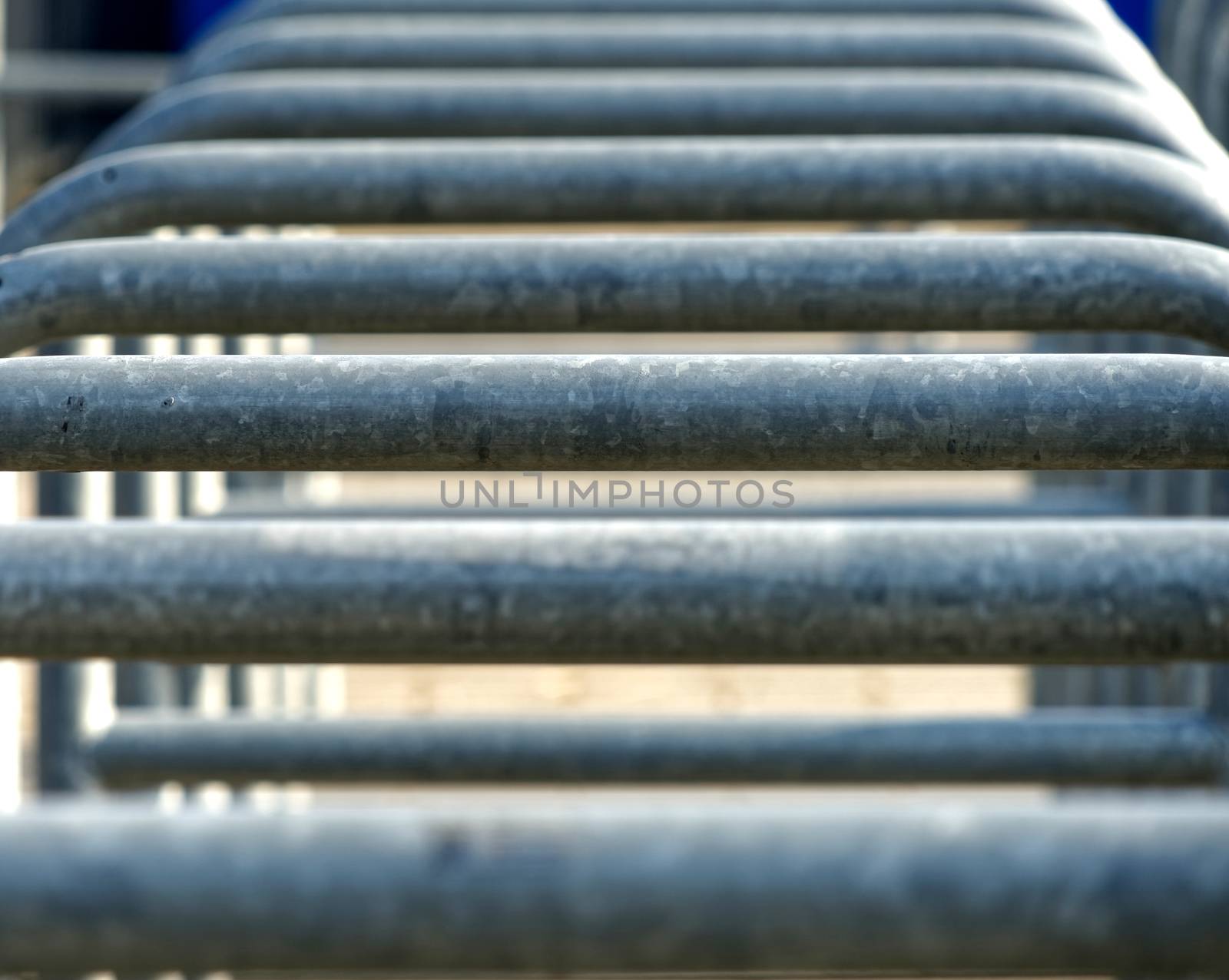 Abstract image with low depth of field (DOF) from the rows of entrances to an arena separated by metal brackets by geogif