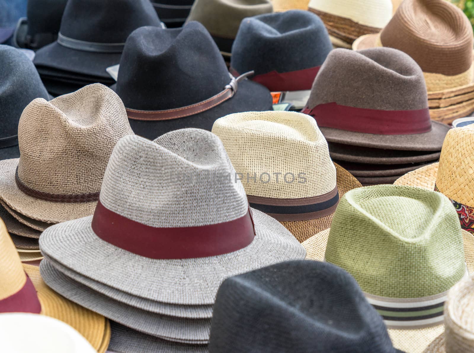 Many hats for men in different shapes and colors in one display for sale, germany