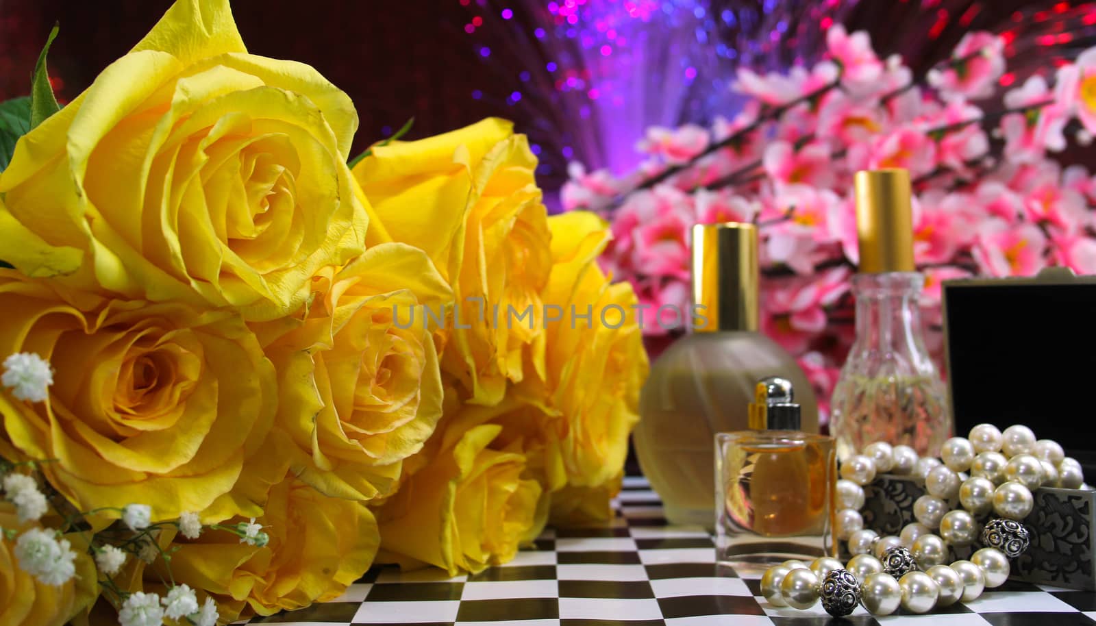 Yellow Flowers With Perfume and Jewelry on Vintage Table